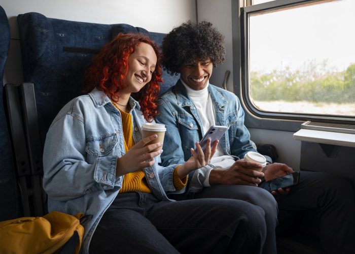 side-view-friends-traveling-by-train